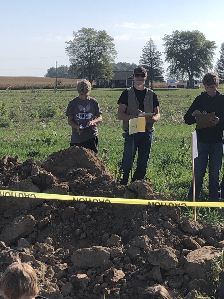 FFA students recording their findings in the hole.