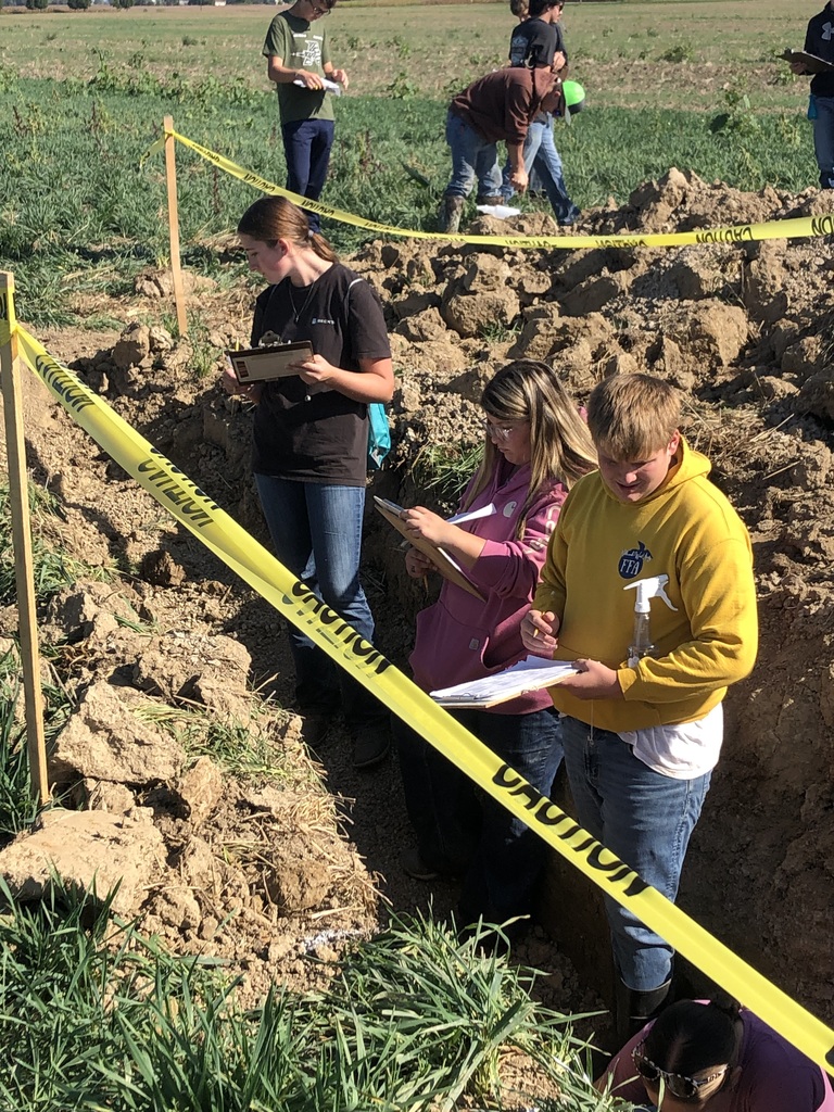 FFA students recording their findings in the hole.