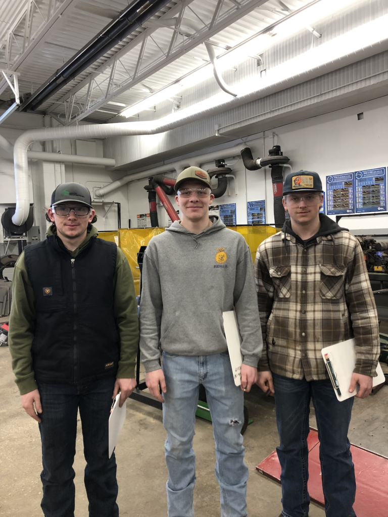 Keagan French, Levi Ankney, and Wyatt Price hold their awards for the FFA District 1 Outdoor Power Equipment contest.