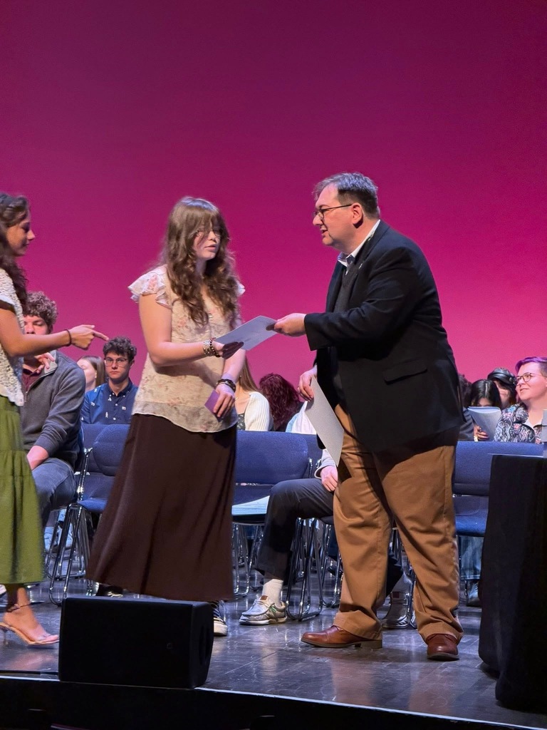 Olyvia takes the stage at the state awards ceremony to receive recognition for her work in the 2026 Ohio Governor's Youth Art Exhibition.