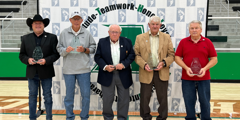 five men holding glass awards, standing in gymnasium