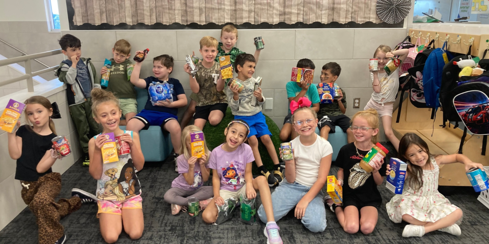 group of students holding donated food