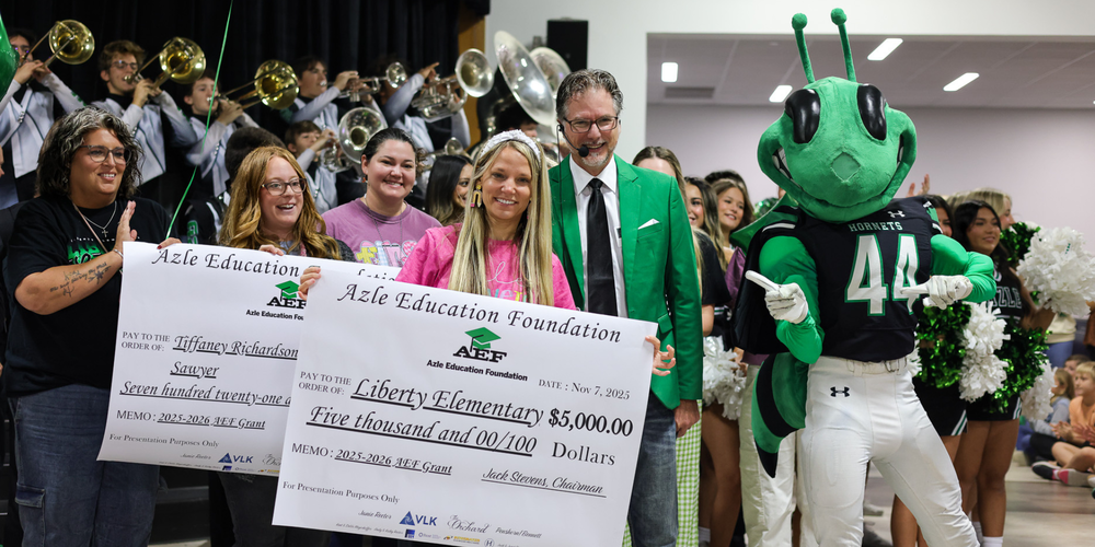 ladies holding up big checks from AEF with buzzy