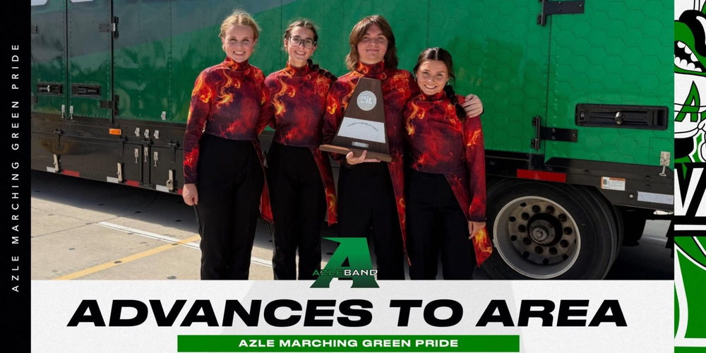 four band students wearing red shirts holding trophy