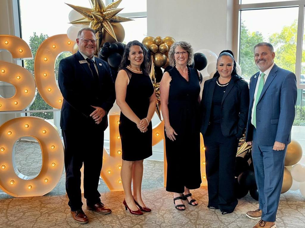 AHS principal,  teacher, EH principal, teacher, superintendent standing in front of lighted letters and balloons