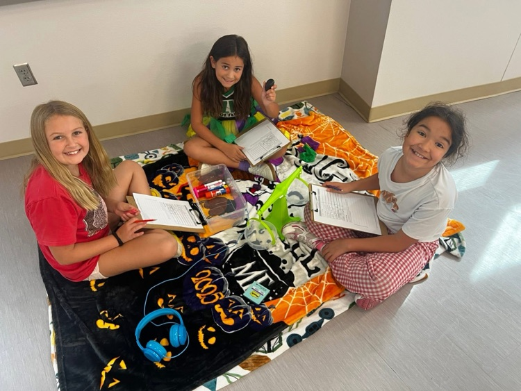 group of girls sitting in floor measuring items