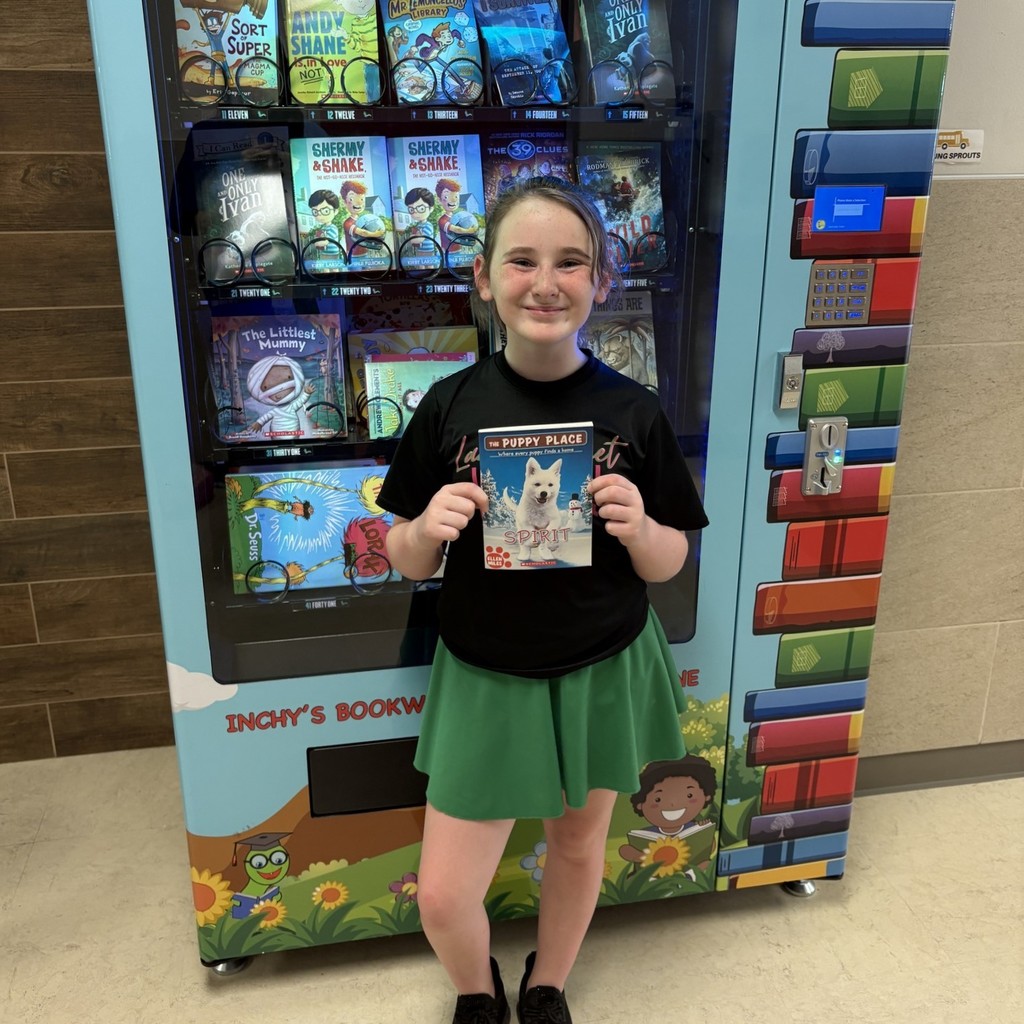 girl holding book, standing in front of book vending machine