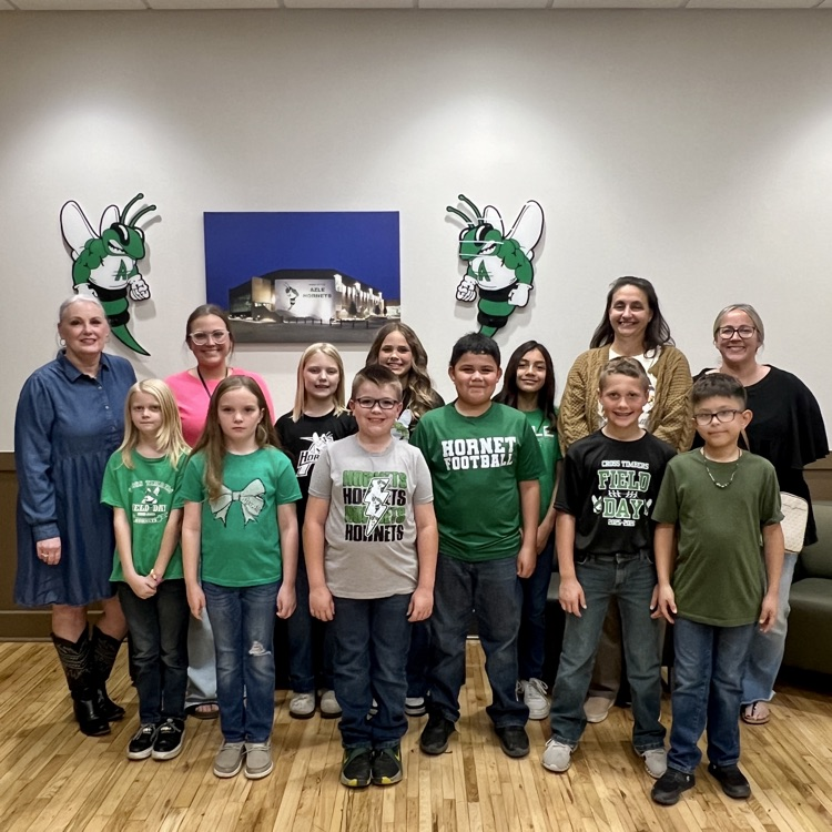 group of students standing in front of Buzzy logos
