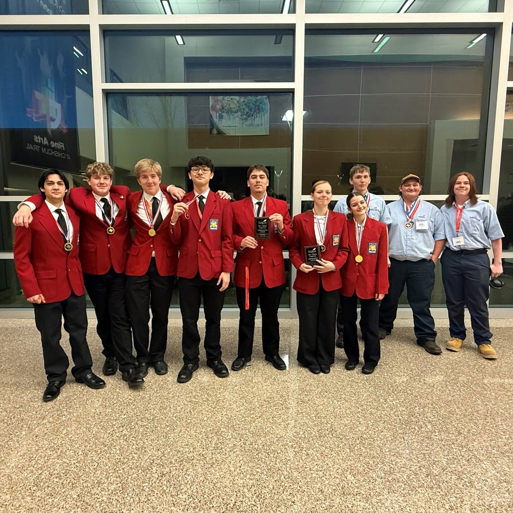 group of Auto Tech students wearing medals and holding awards