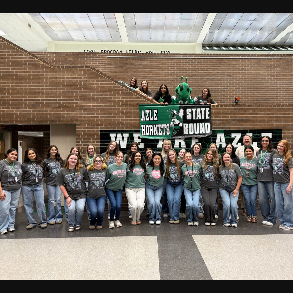 Dazzlers in a group with "Azle Hornets State Bound" banner and Buzzy