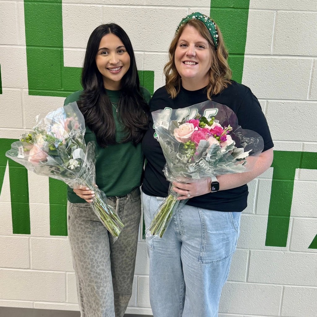 Ms. Mendoza and Ms. Tarpley holding flowers