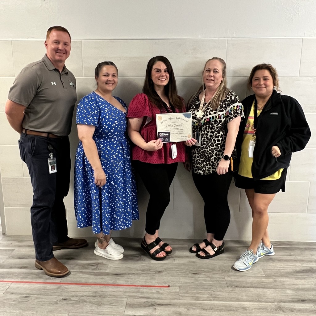 man and three women holding certificate and gift card