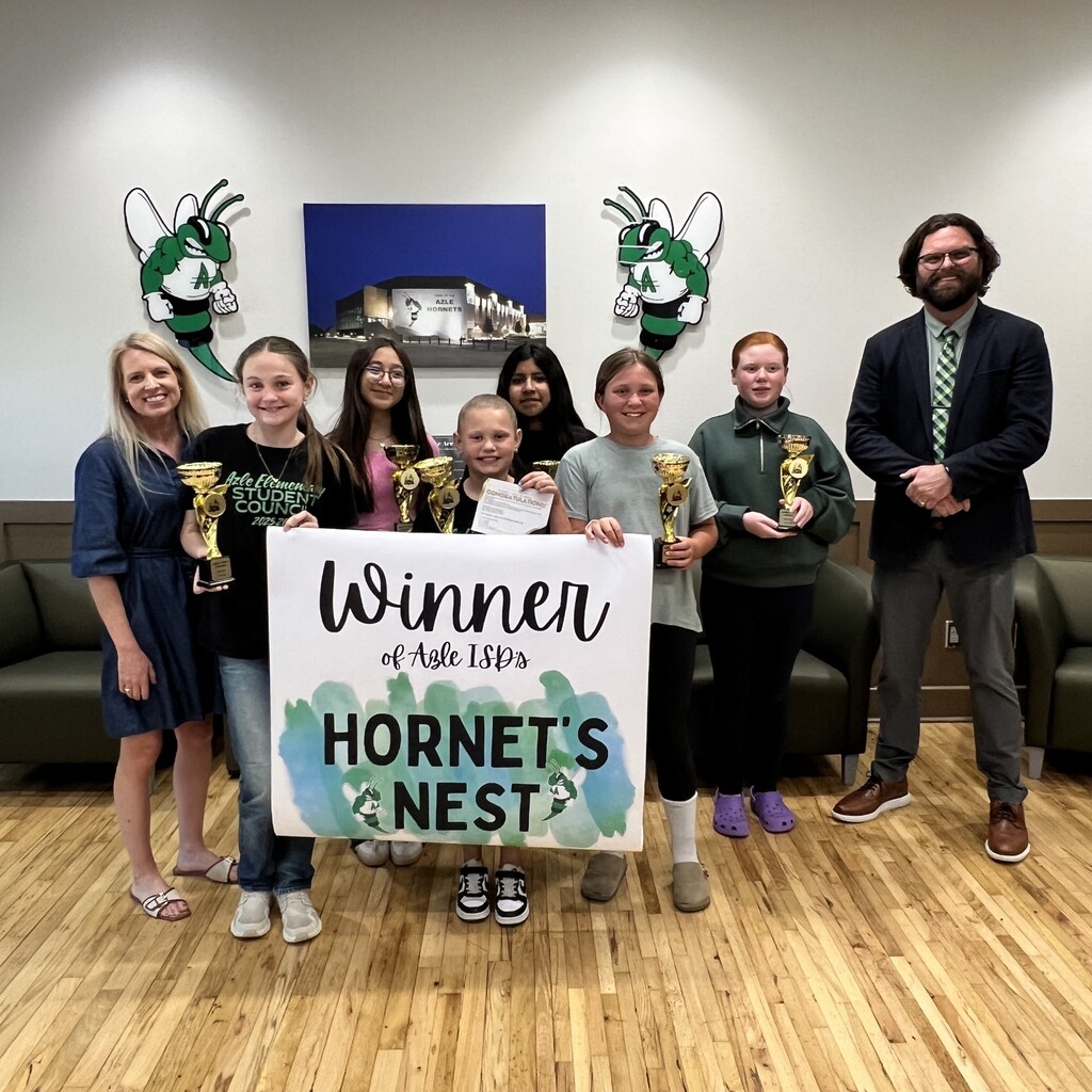 group of students holding trophy and banner that reads "Winner of Azle ISD's Hornet's Nest"