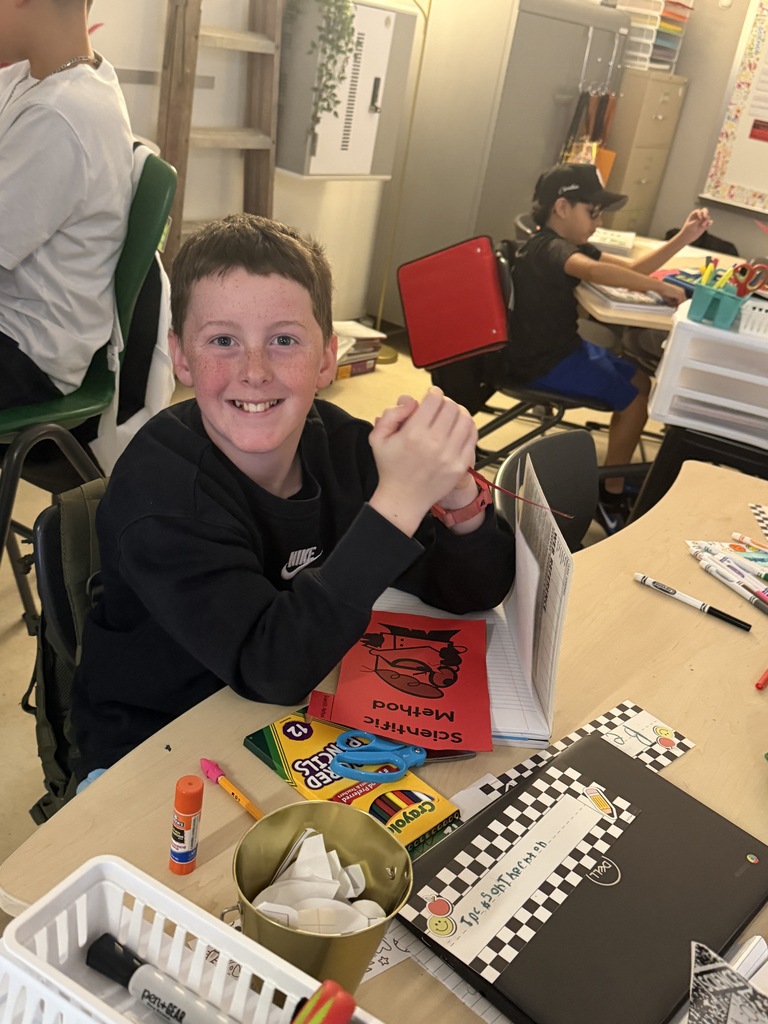 Student sitting at desk with notebook