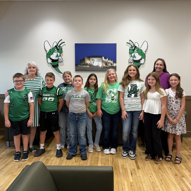group of students standing in front of Buzzy logos