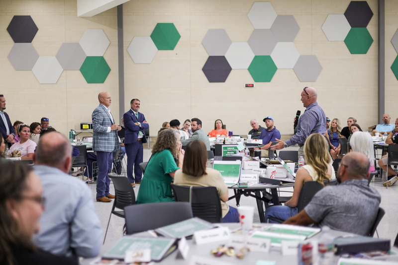 group of people sitting at tables meeting