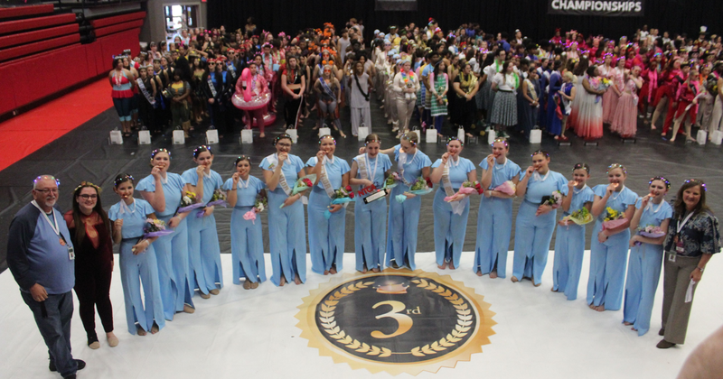 Varsity Colorguard wearing their 3rd place medals at the NTCA Championships