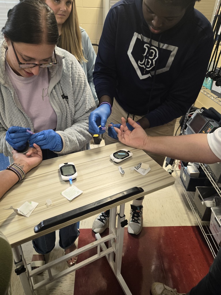 Allied Health students checking blood sugar levels of faculty members