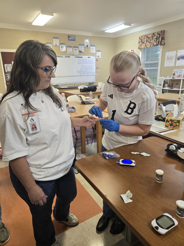 Allied Health students checking blood sugar levels of faculty members