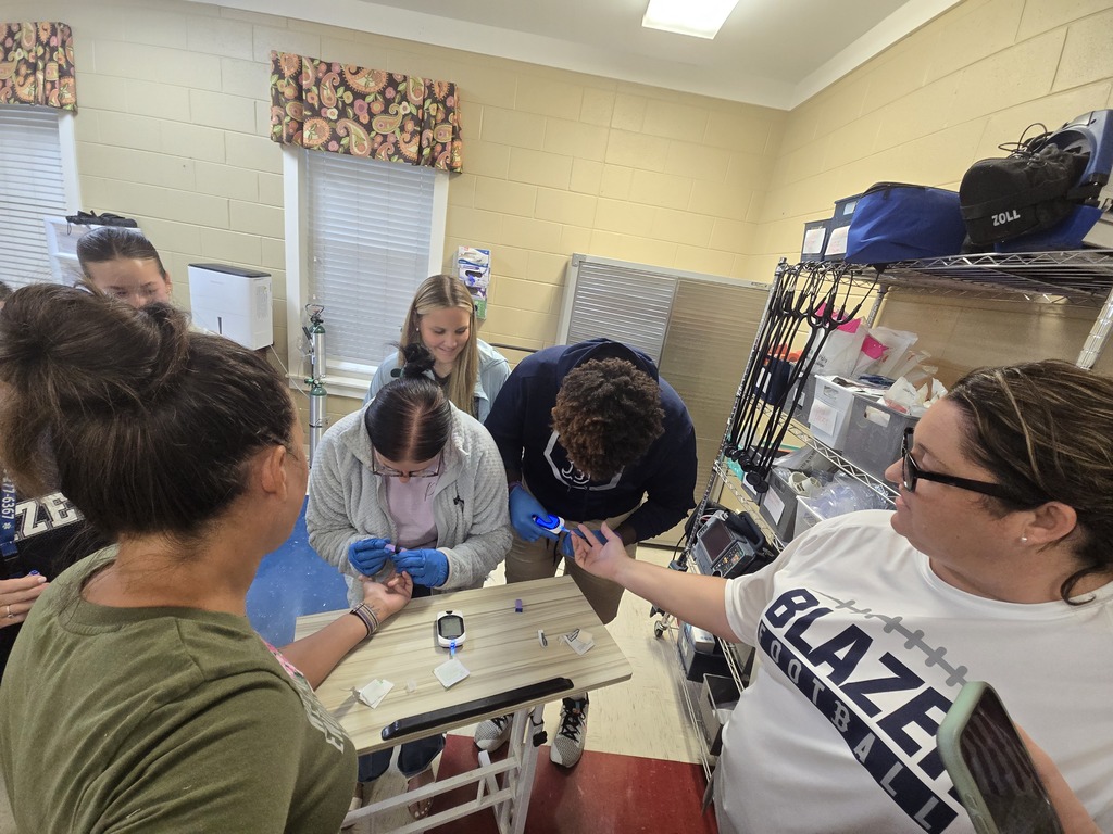 Allied Health students checking blood sugar levels of faculty members