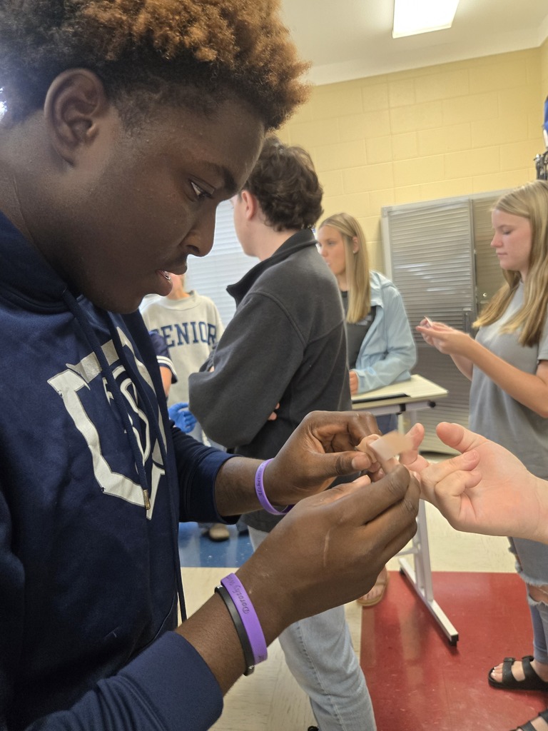Allied Health students checking blood sugar levels of faculty members