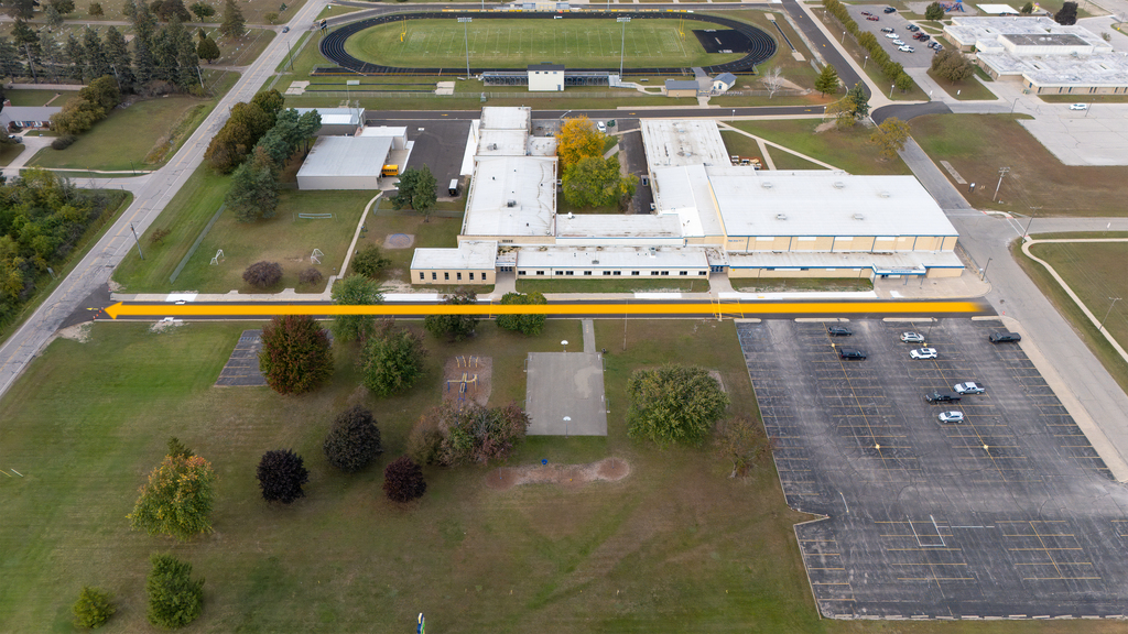 Bad Axe Middle School Aerial Shot with driveway path and arrow pointing east to west.