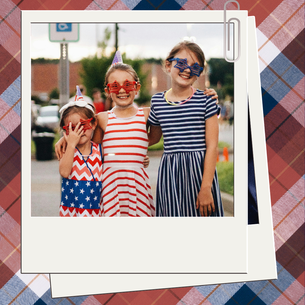 Polaroid Picture with three girls dressed in red, white, and blue with a plaid background.