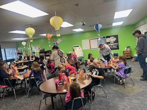 High School FFA students doing Thanksgiving crafts & reading to kindergarten students.