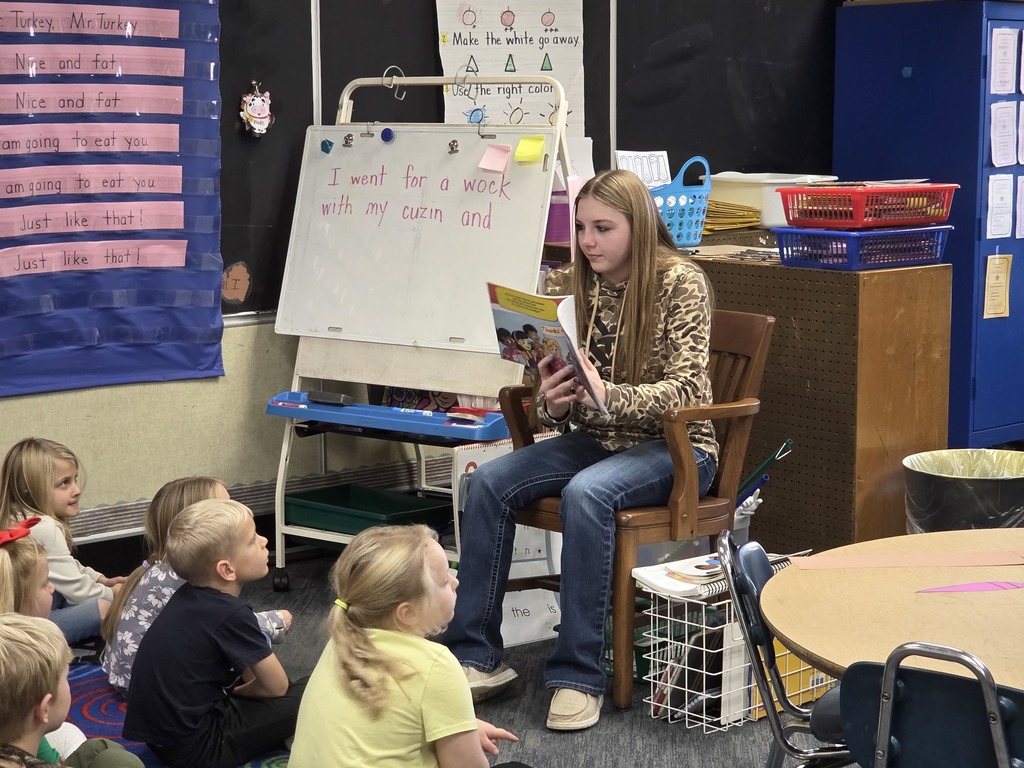 High School FFA students doing Thanksgiving crafts & reading to kindergarten students.