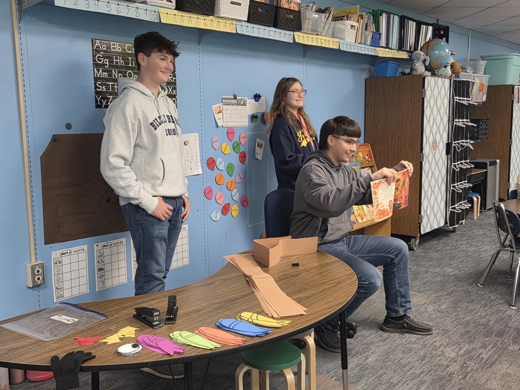 High School FFA students doing Thanksgiving crafts & reading to kindergarten students.