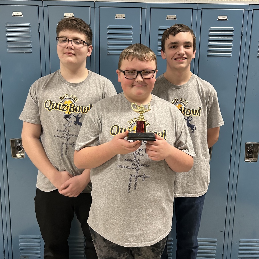 Bad Axe Middle School Students standing in front of the lockers holding their 2nd place trophy.