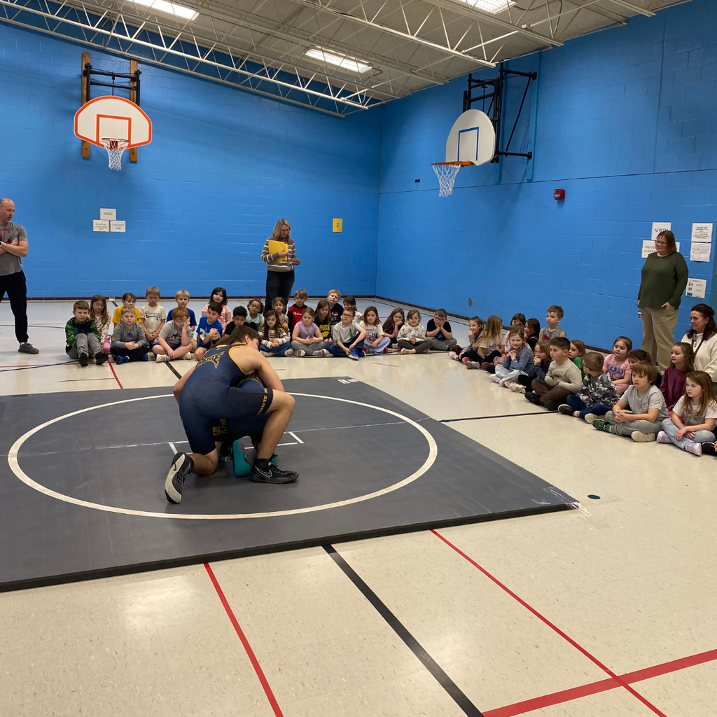 Bad Axe Varsity Wrestling Team with Coach Hollingsworth & Coach Sutherland teaching the 1st-graders how to wrestle.