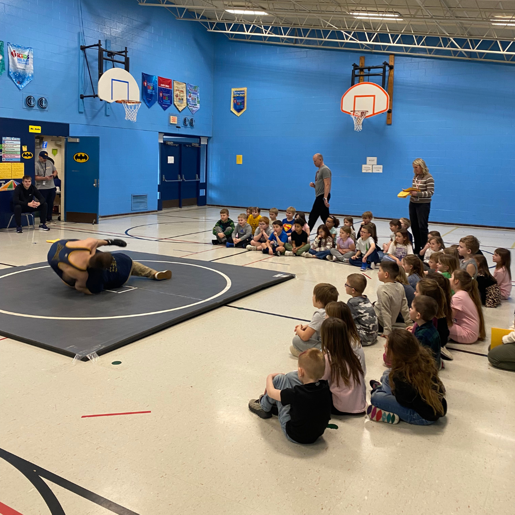 Bad Axe Varsity Wrestling Team with Coach Hollingsworth & Coach Sutherland teaching the 1st-graders how to wrestle.