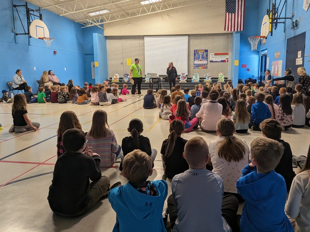 Students at Bad Axe elementary School sit crisscross in the gym for a Kids Heart Challenge Presentation. 