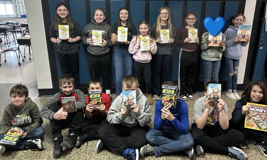 Students from Ms. Krug's class holding up their new books.