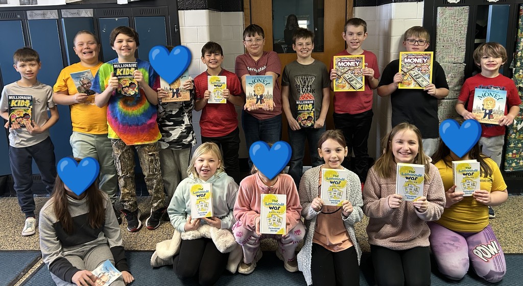 Students from Mrs. Wessel's class holding up their new books.