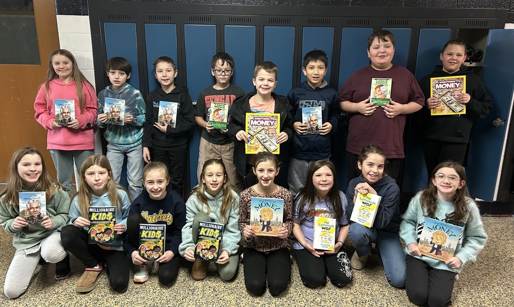 Students from Mrs. Lacy's class holding up their new books.
