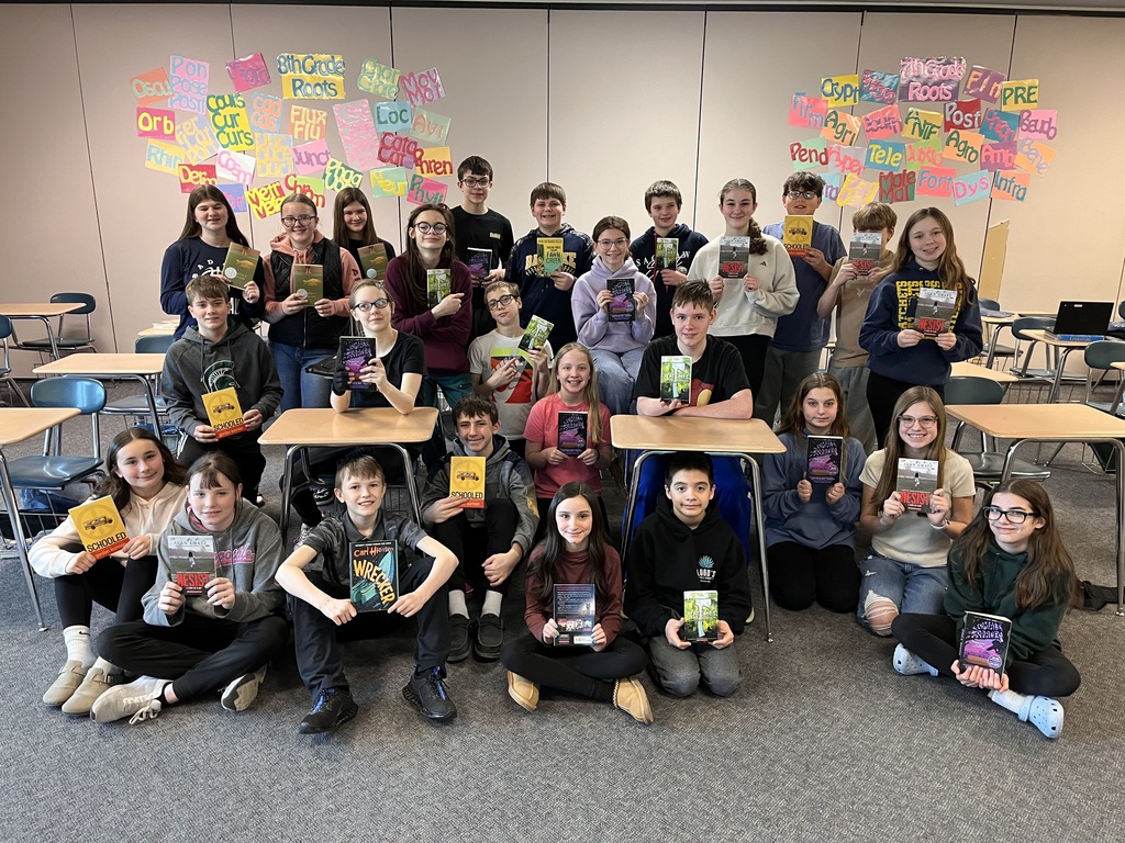 7th & 8th grade ELA students at BAPS pose with their new books.