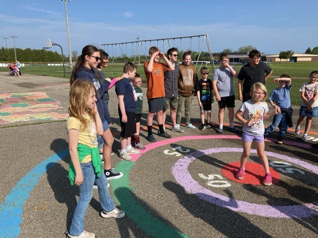 Art students from Mr. Snider's art class have outdoor fun with second graders.