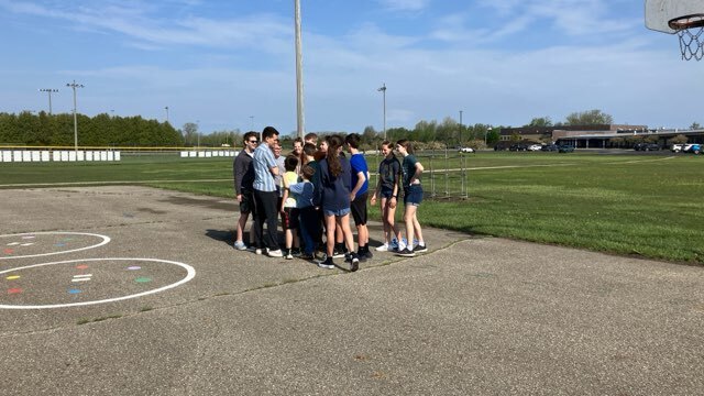 Art students from Mr. Snider's art class have outdoor fun with second graders.
