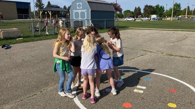 Art students from Mr. Snider's art class have outdoor fun with second graders.