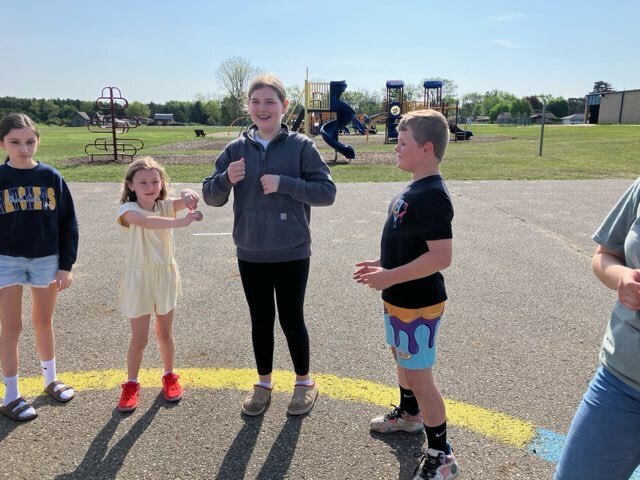 Art students from Mr. Snider's art class have outdoor fun with second graders.