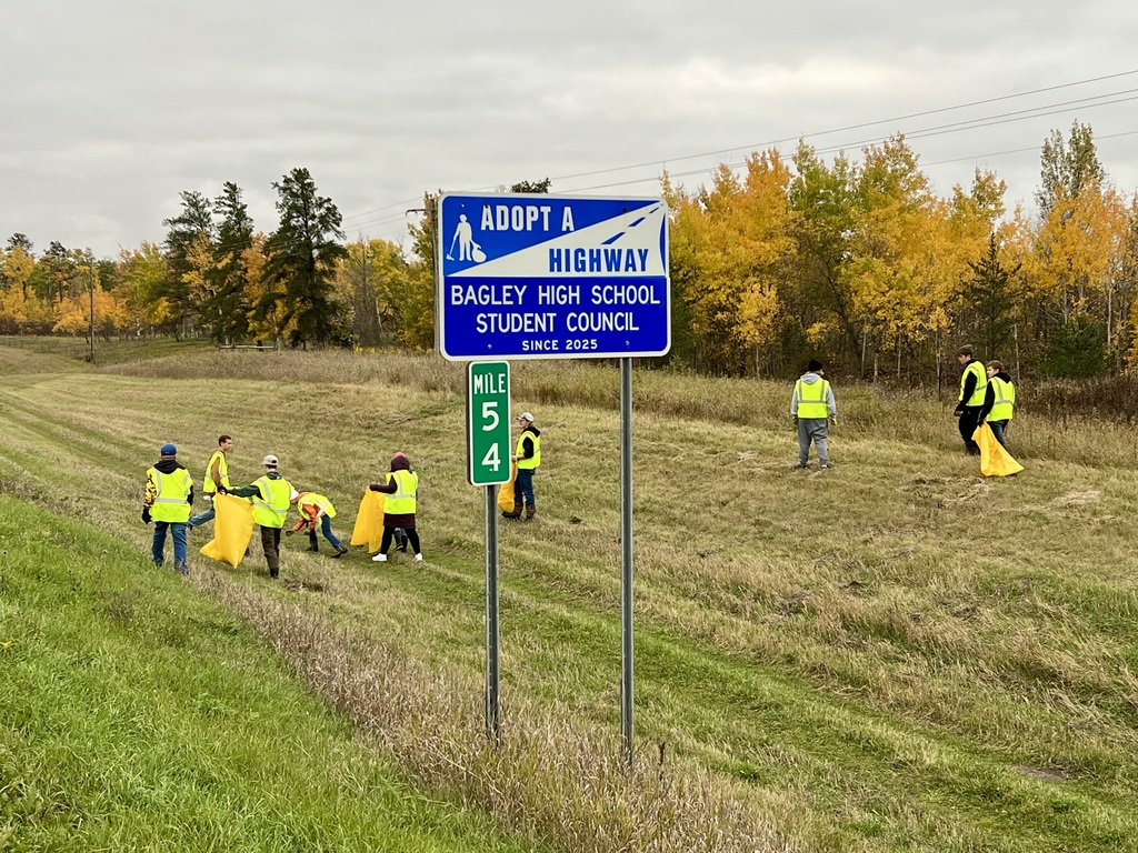 some of the members walking the ditches with their trash bags as they clean ditches.