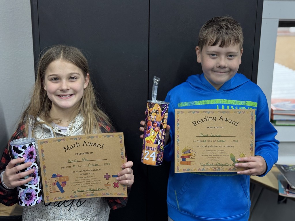 photo of students with prizes and certificates.