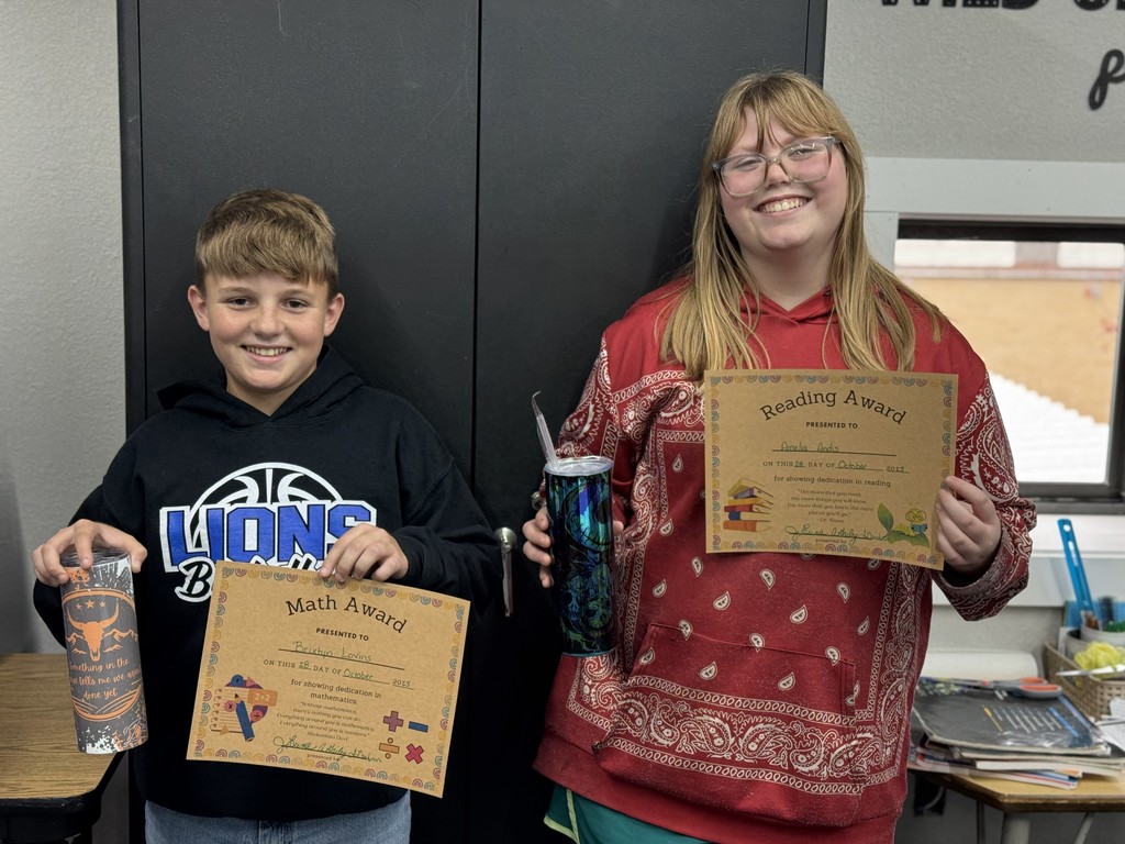 photo of students with prizes and certificates.