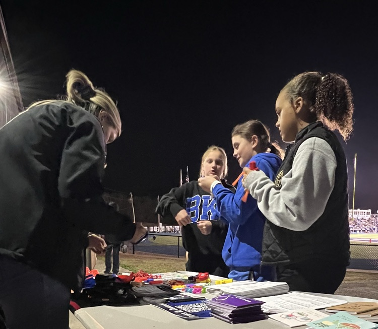 Students visiting the table and checking out the free mental health resources