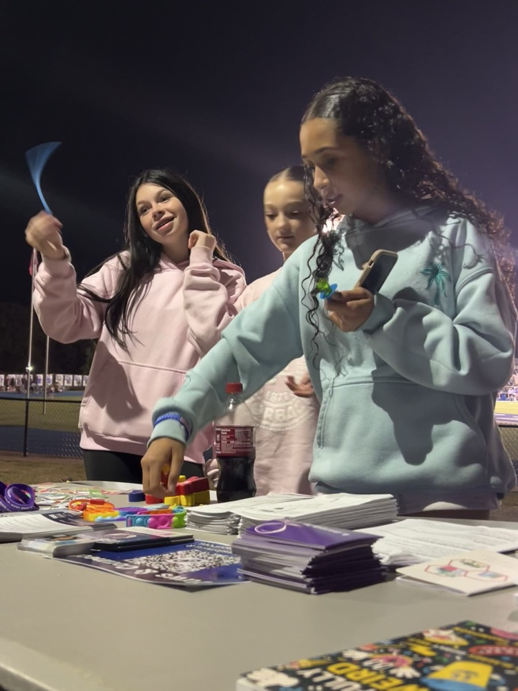 Students visiting the table and checking out the free mental health resources