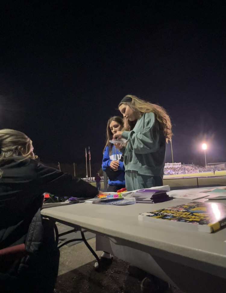 Students visiting the table and checking out the free mental health resources