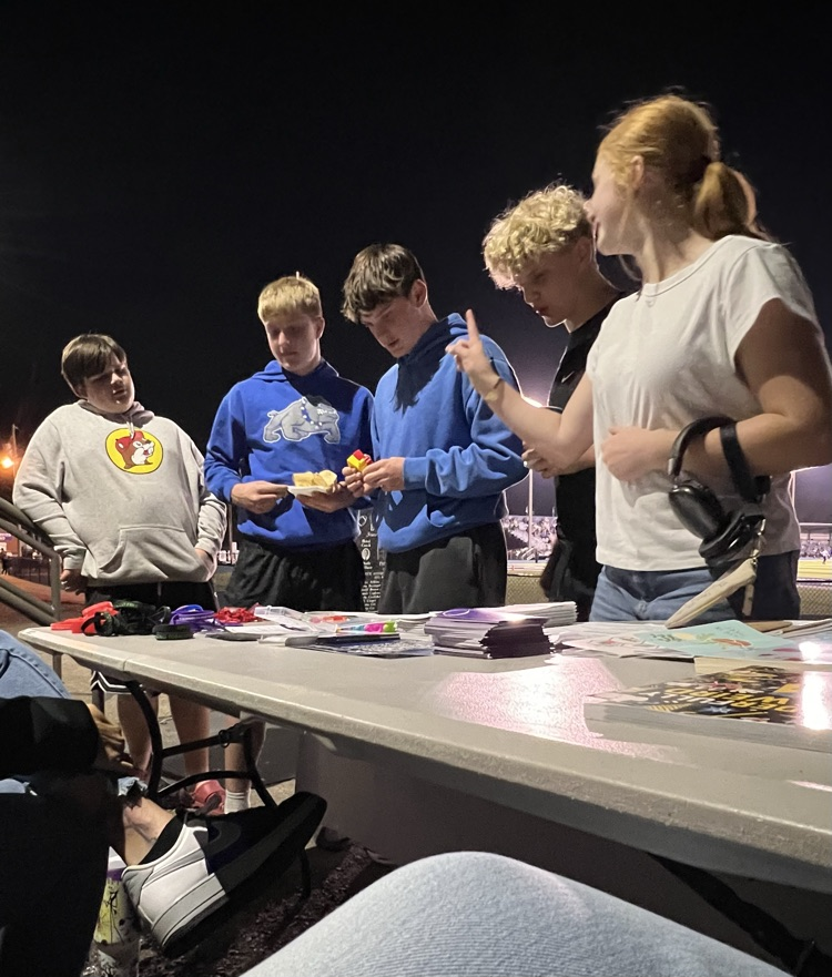Students visiting the table and checking out the free mental health resources