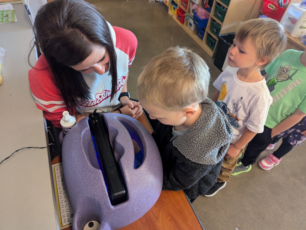 Student looking at germs on hands